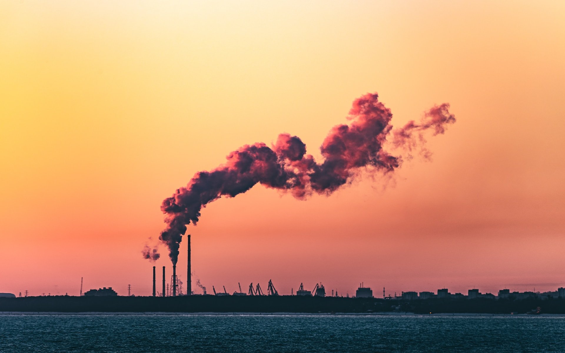 Industrial plants with smoking chimneys in the evening light